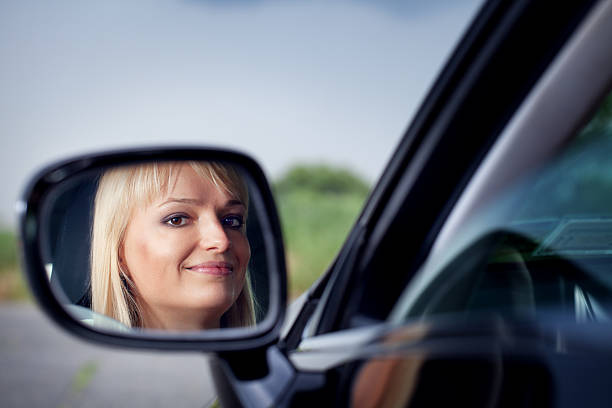 istock Woman driver looking at side-view mirror 182831379