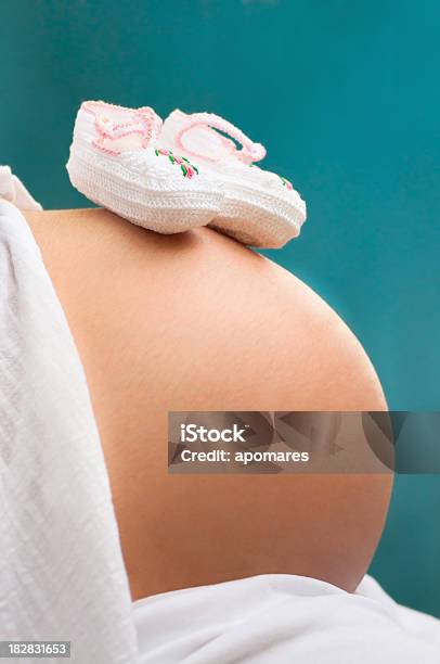 Baby Shoes On Pregnant Woman Belly Stock Photo - Download Image Now - 20-29 Years, Abdomen, Adult