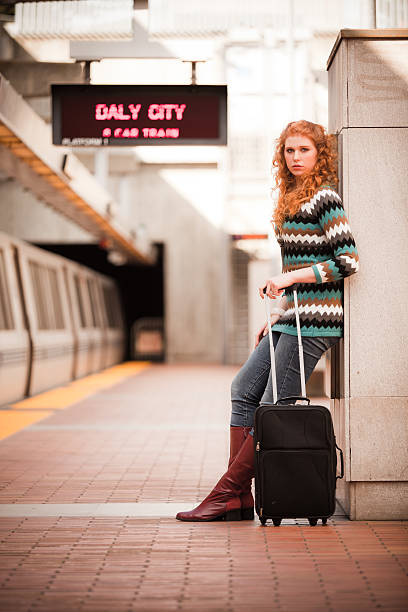 istock Girl with suitcase at BART station 182832095