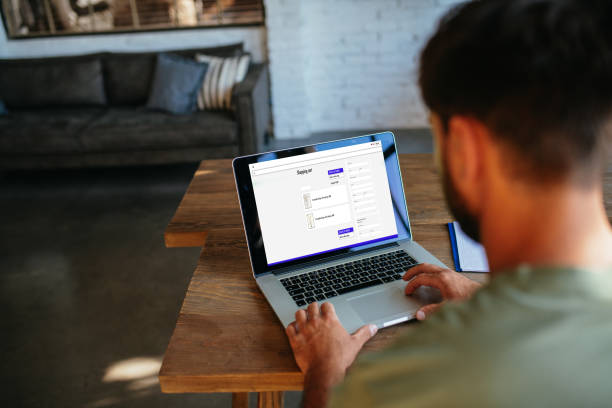 istock Young handsome man working from home and logging on the e-commerce or webshop webpage 1828324972