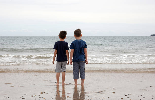istock Two young boys at the water's edge 182832660