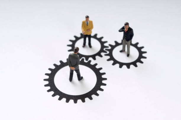 istock Three men standing in circles shaped liked gears 182832760