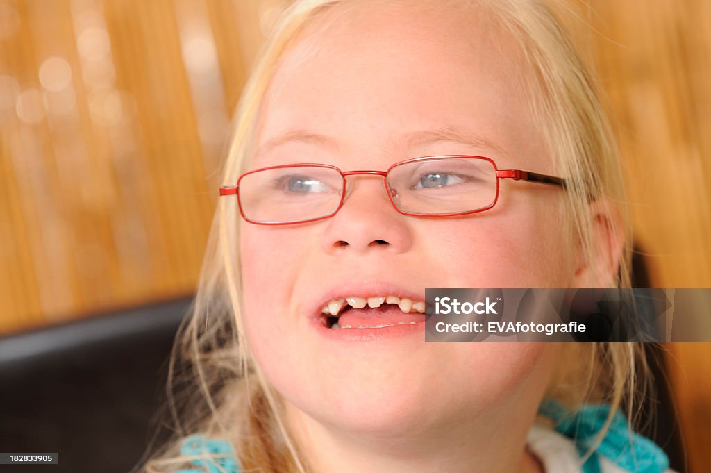 Girl with down syndrome laughing Seven year old girl with down syndrome laughing. 6-7 Years Stock Photo