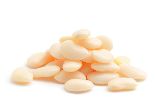 A close up shot of a pile of Butter Beans isolated on white.
