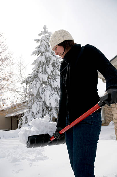 istock Woman Holding Snow Shovel 182835761