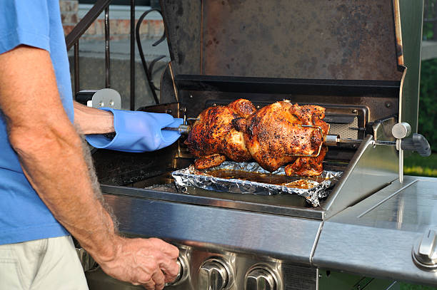istock Man cooking barbecue chicken on grill, outdoor 182836117