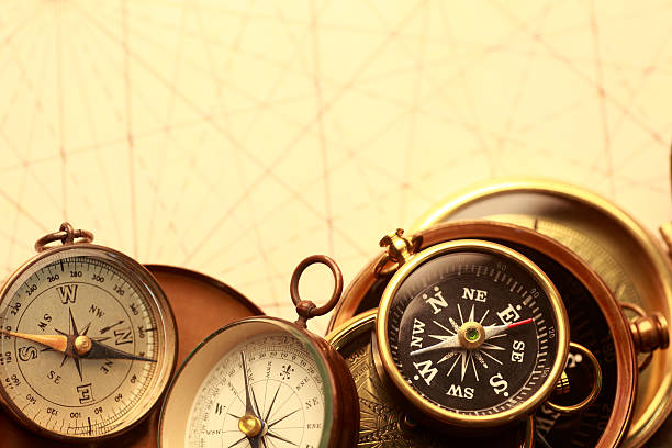 istock Several Compasses Stacked On Top Of One Another On Old Map 182836375