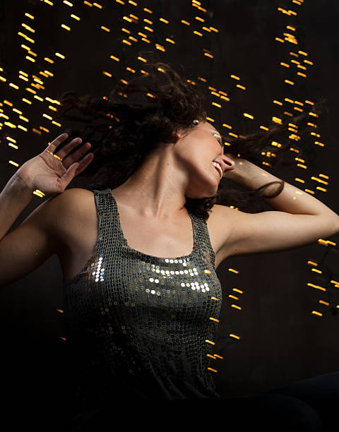 dancing young woman with club lights stock photo