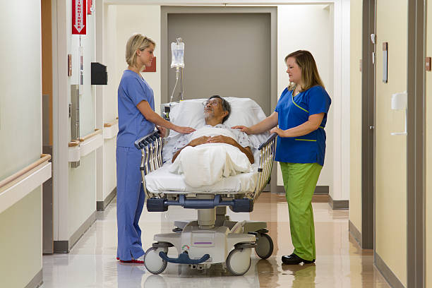 istock Two Healthcare Workers Comforting Patient 182836569