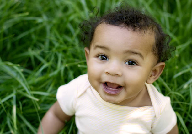 istock Sweet baby in grass looking up 182837120