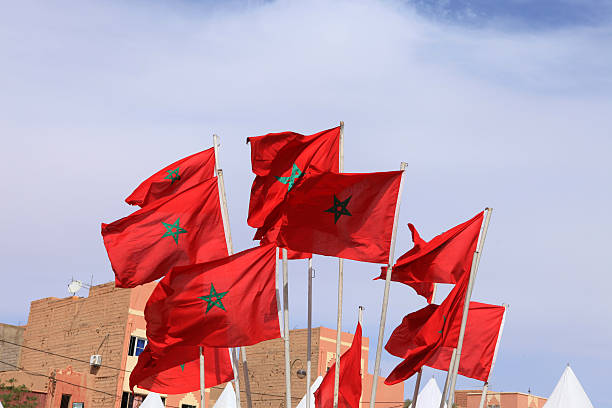 Small Moroccan flags, houses and sky in village Erfoud, Morocco stock photo