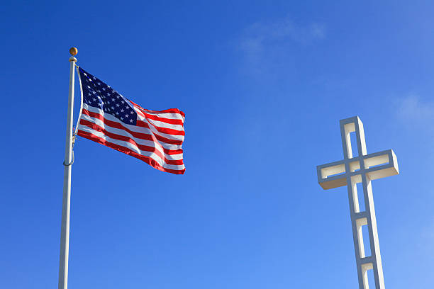 istock US Flag and Cross in Blue Sky 182837247
