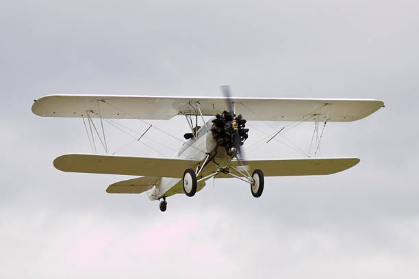 White Biplane Flying 4 stock photo