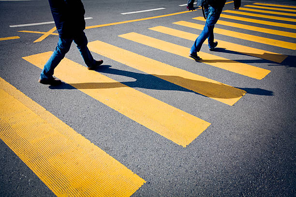 istock Bright yellow segmented crosswalk being used by pedestrians 182837459