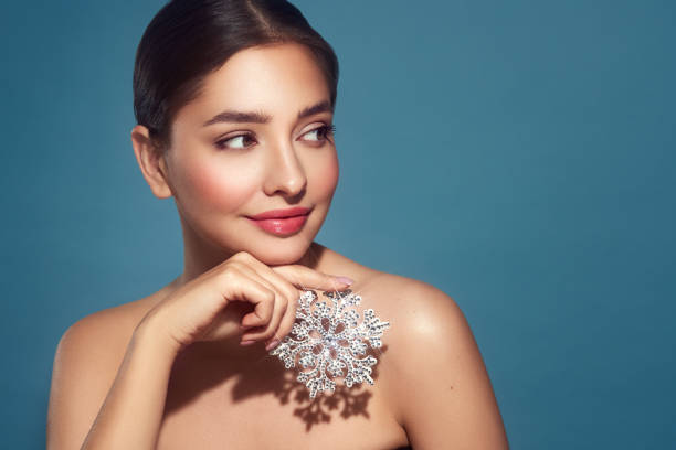 istock Beautiful young woman with glowing snowflake 1828374914