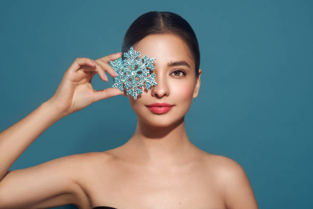 Beautiful young woman with glowing snowflake