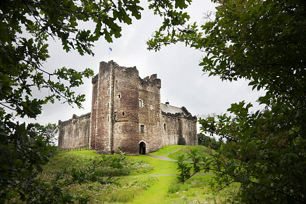 Doune Castle "The 14th century Doune Castle near Stirling, Scotland, seen through trees.Doune Castle is perhaps most famous as the location for several scenes in Monty Python and the Holy Grail." circa 14th century stock pictures, royalty-free photos & images