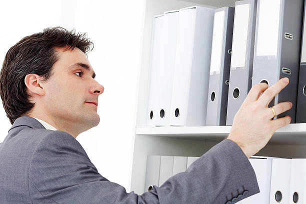 istock Business man looking at the register document 182837594