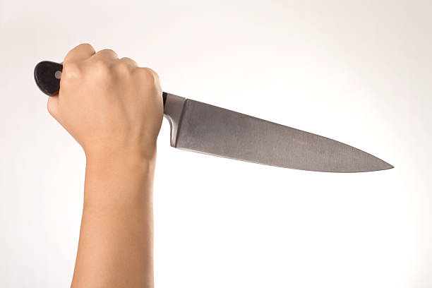 istock Woman holding a large kitchen knife 182837854