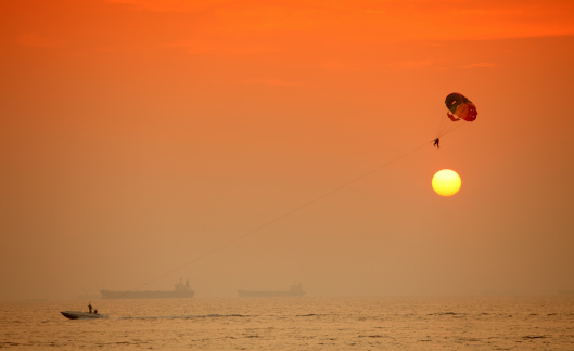 Parasailing on the sea at sunset, Goa, India