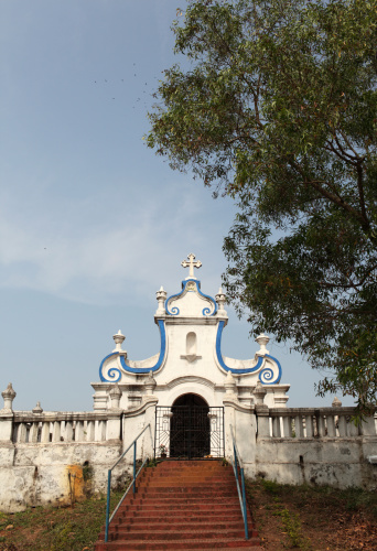 This image features the historic churches of Old Goa, a UNESCO World Heritage Site known for its well-preserved examples of religious architecture dating back to the Portuguese colonial era. The churches, such as the Basilica of Bom Jesus and the Se Cathedral, stand as majestic landmarks with intricate facades, large courtyards, and imposing towers. The photograph aims to capture the grandeur and architectural finesse of these religious edifices, while also shedding light on their historical significance. Through the lens, viewers get a sense of both the spiritual and cultural importance these churches hold, serving as both tourist attractions and places of worship that have stood the test of time.