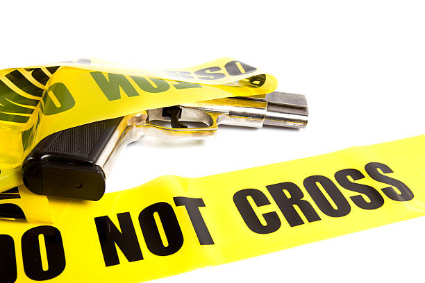 istock Crime Scene Cordon Tape And Handgun 182838251