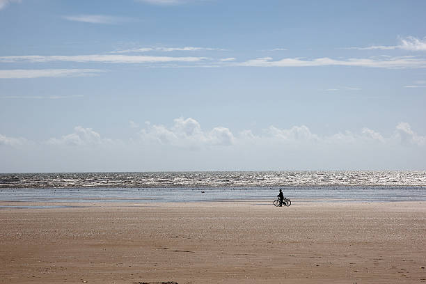 istock Cyclist in silhouette on the beach 182838283