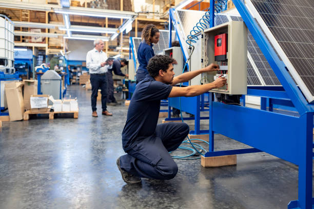 istock Engineer installing solar panels at a manufacturing factory 1828385310