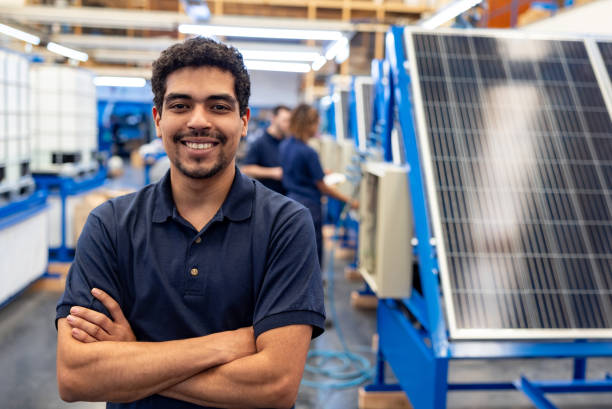 istock Happy employee working at a solar panel factory 1828385311