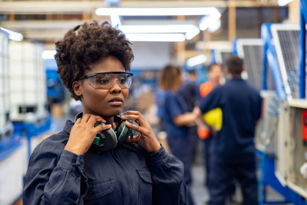istock Employee working at a solar panel factory wearing protective workwear 1828385323