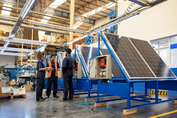 Group of workers in a meeting at a solar panel factory Group of Latin American workers talking in a meeting at a solar panel factory - green technology concepts solar panel manufacturing stock pictures, royalty-free photos & images