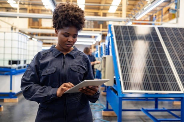 istock Woman working at a solar panel factory and using a digital tablet 1828385331