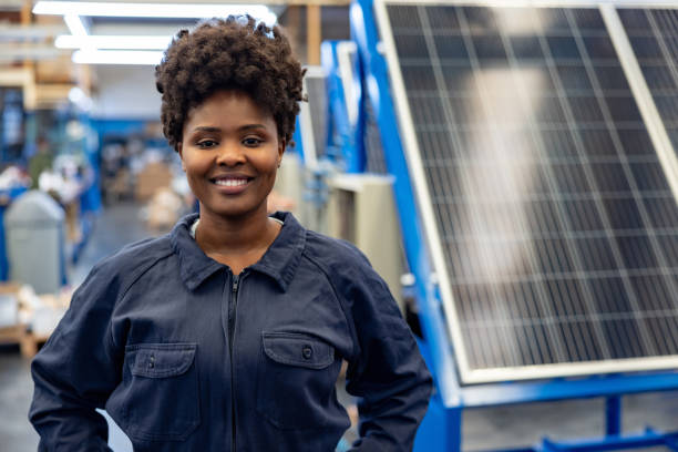 istock Happy employee working at a solar panel factory 1828385350