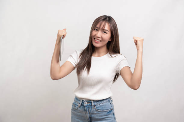 istock Young asian woman using tablet over white background, technology concept 1828385364
