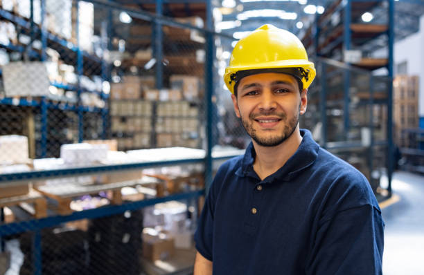 Happy man working at an industrial warehouse