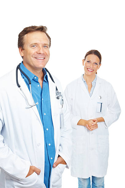 istock Smiling mature doctors standing against white background 182838673