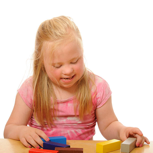 istock Disabled girl is playing with wooden blocks 182838691