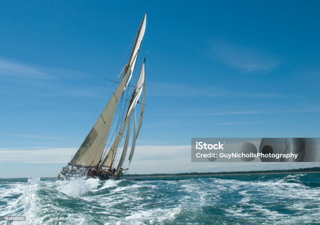 Under sail "A superb yacht under full sail, tacking her way west down the Solent (southern UK).  The sailing community of Cowes (UK - Isle of Wight) is just astern of her.  What a majestic sight she made, such a beautiful lady.  Many more boats and ships in my light box." Sailboat Stock Photo