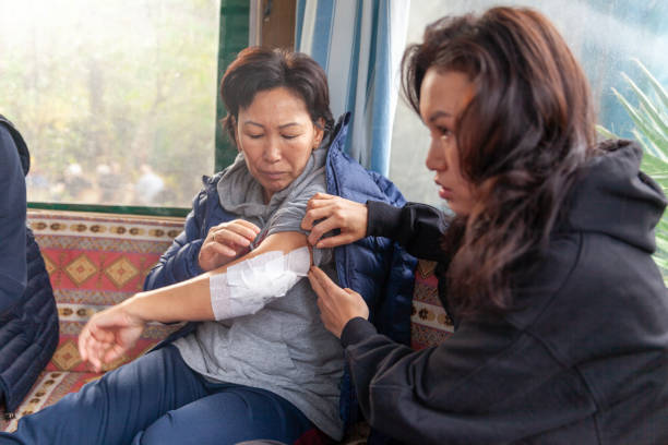 istock Daughter shows her mother's bandaged arm 1828389633
