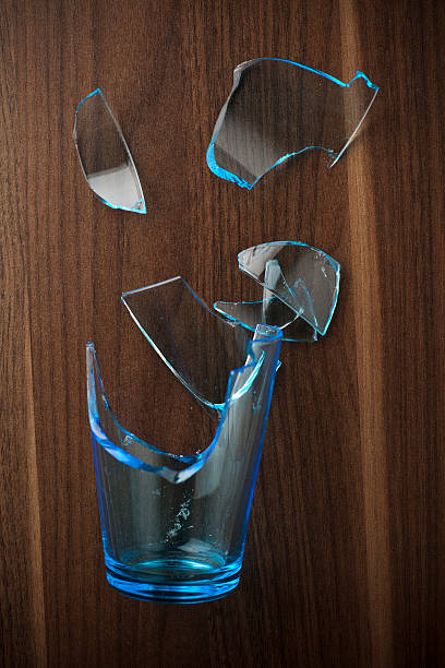 istock Broken glass on dark wooden background 182839662
