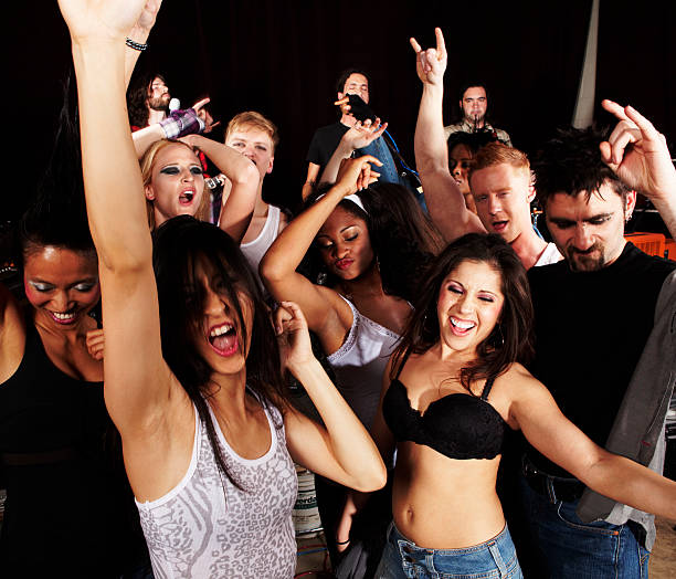 istock Wild, rambunctious group of young people at a rock concert 182840241