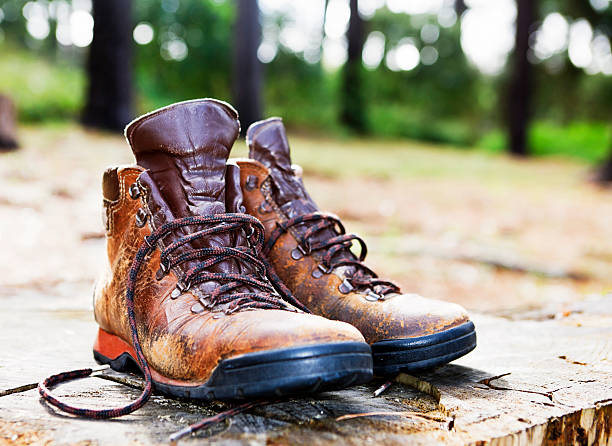 istock Pair of worn hiking boots in forest clearing 182840465