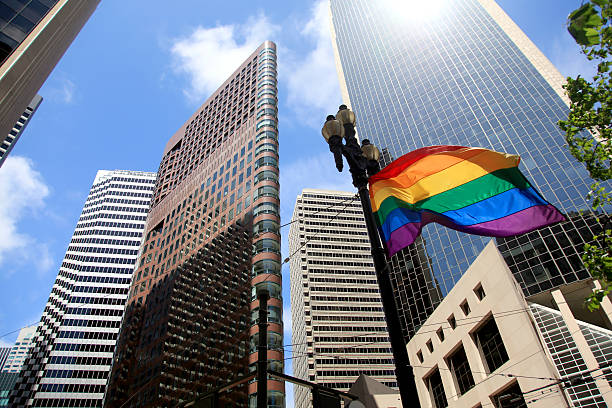 Gay pride flag Gay pride flag against modern background in San Francisco pride flag office stock pictures, royalty-free photos & images