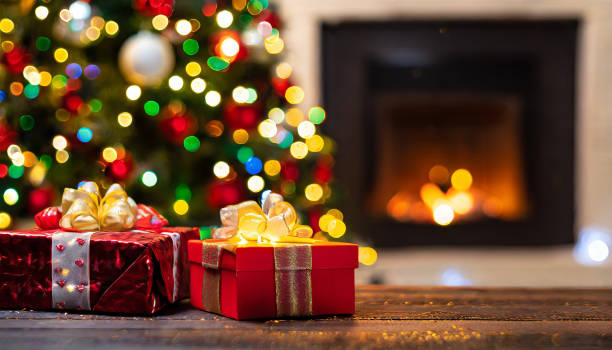 istock Christmas gifts with Christmas tree next to fireplace 1828416484