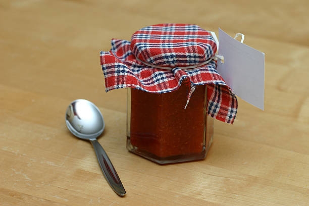 istock Glass with red jam and tea spoon 182842076