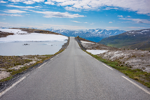 The mountain road Aurlandsfjellet between Aurland and Lærdal, Norway, nicked named  snow road is open for travel from June 1 to mid Oct.  It's highest point is 1306 meters.