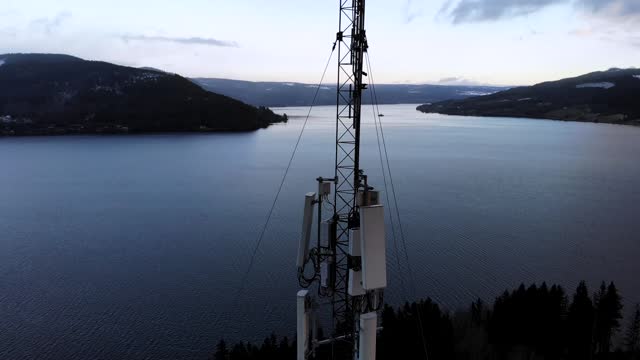 5G installation work on high mast in forest