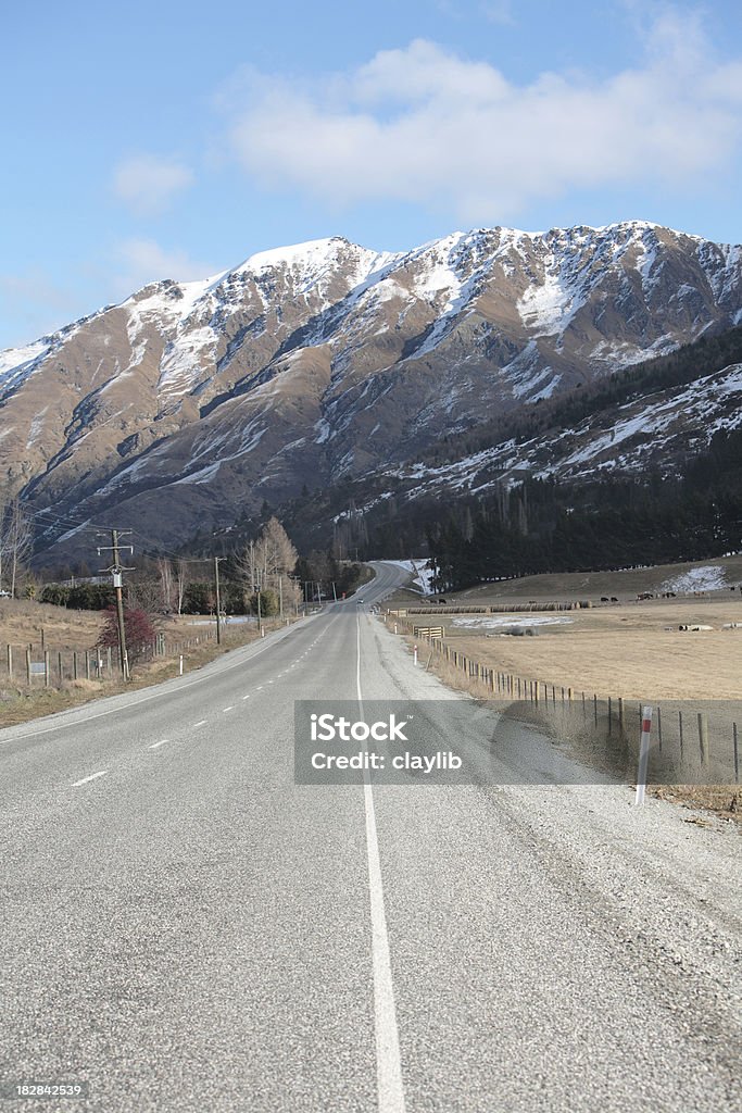 road and snow covered range "scene outside Queenstown, New Zealand" Asphalt Stock Photo