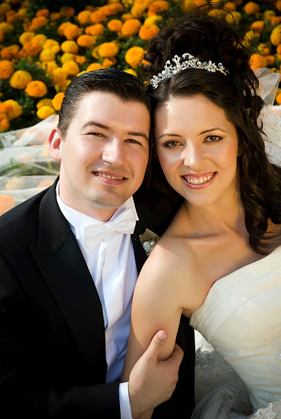 istock Newlywed couple among flowers 182842572