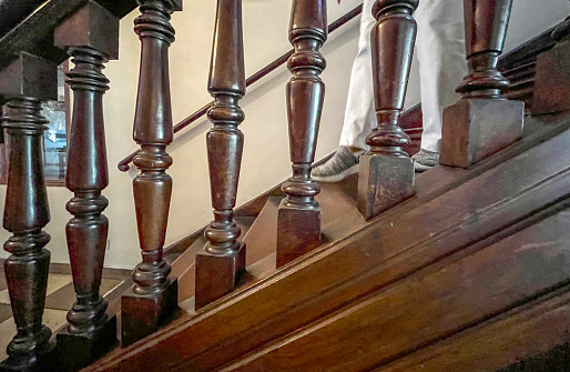 Woman walking down staircase side view